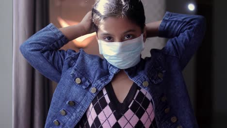 a young girl wearing a mask in a office hall