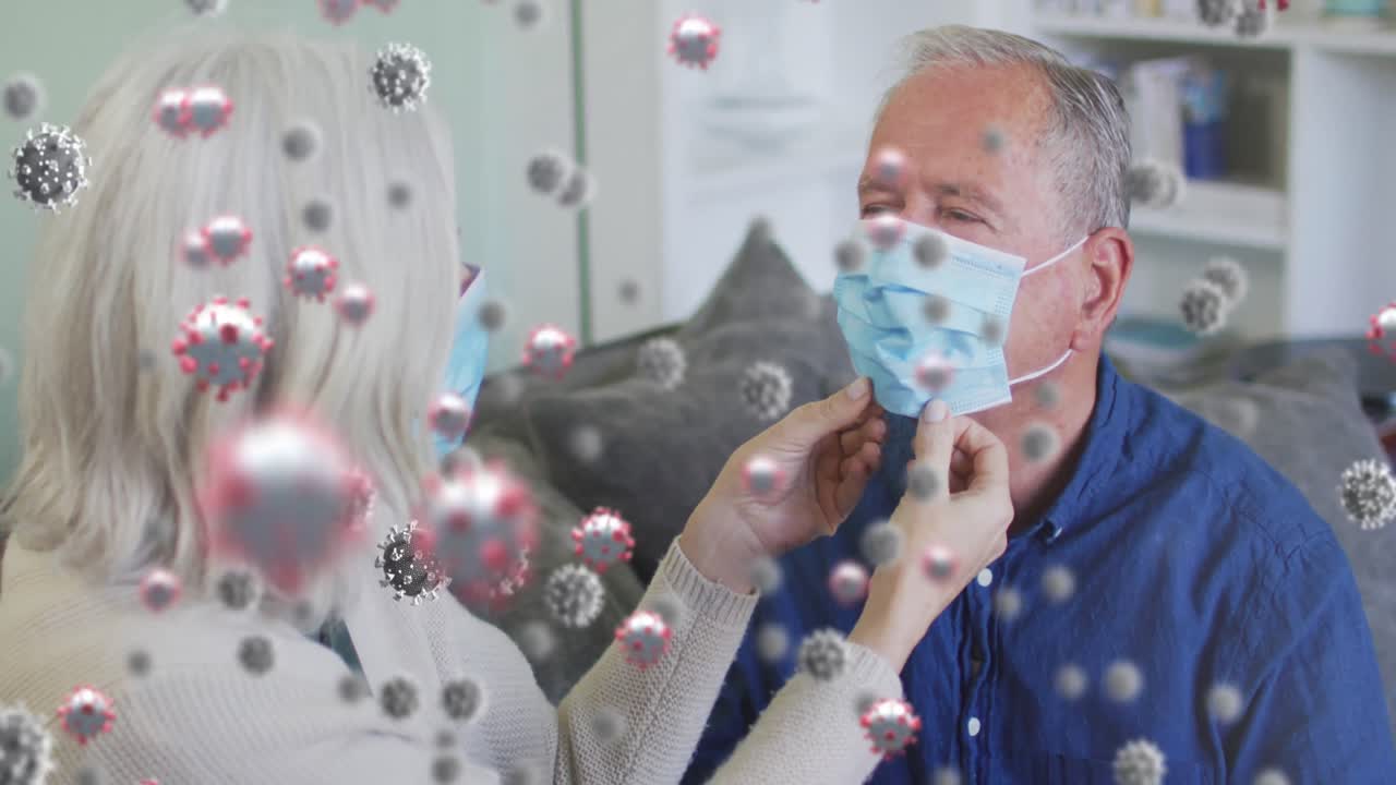 얼굴 마스크를 착용한 고령 백인 부부 위의 바이러스 세포의 애니메이션