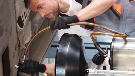 auto mechanic performing fluid change on a car