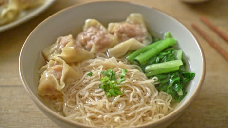 egg noodles with pork wonton soup or pork dumplings soup and vegetable - asian food style