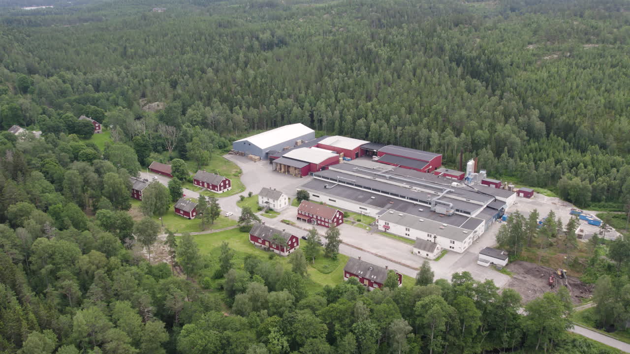 Bäckefors Bruk seen from above, showing factory and surrounding lush forest area