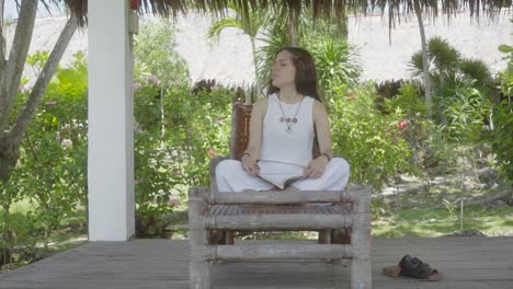 Relaxed-girl-reading-a-book-in-an-exotic-hotel-in-the-jungle