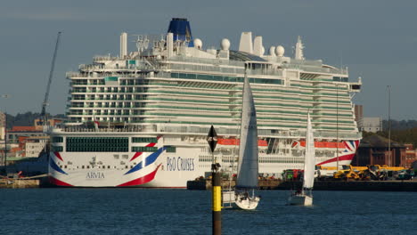 p and o cruise ship arvia at southampton docks with sailboats in foreground