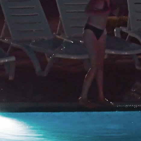 swimming pool at a luxury, tropical resort at night