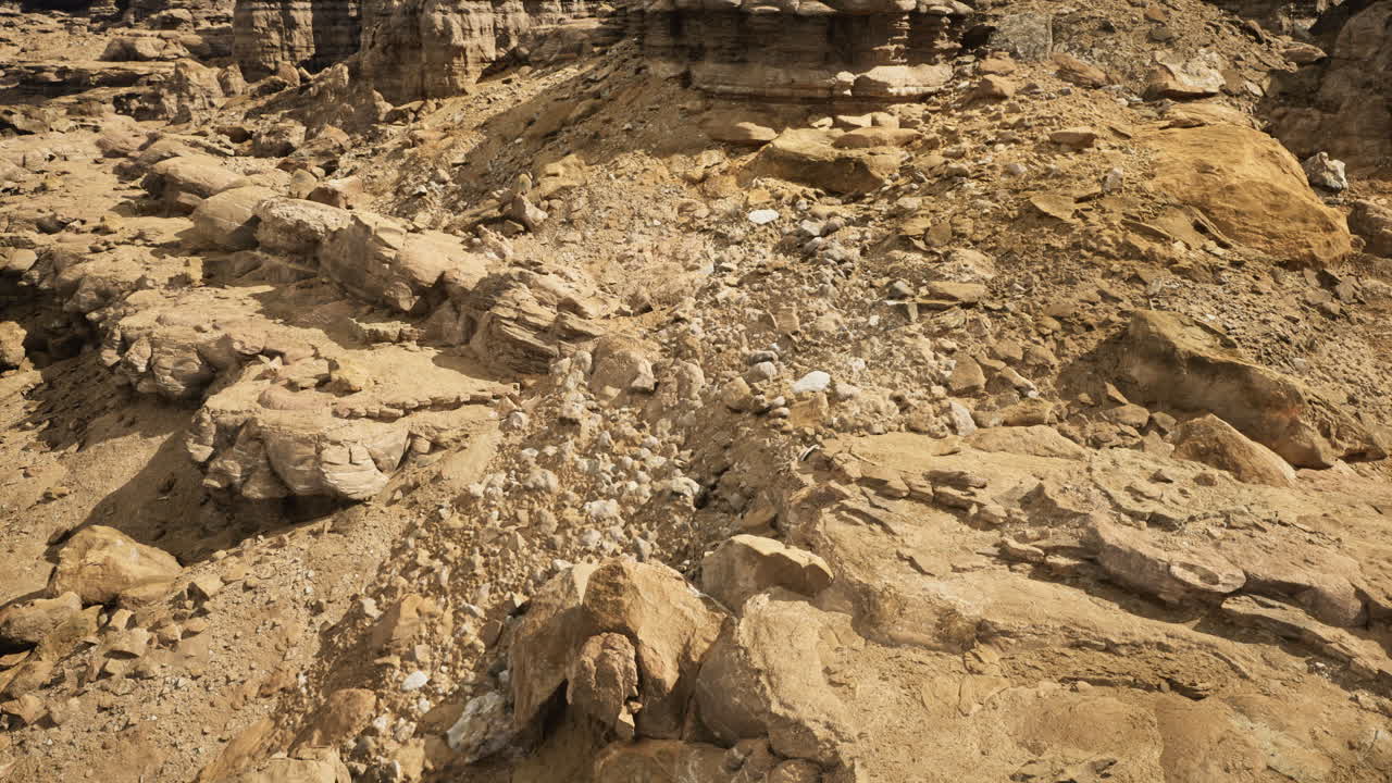 Rock formations and erosion patterns in a desert landscape during daylight