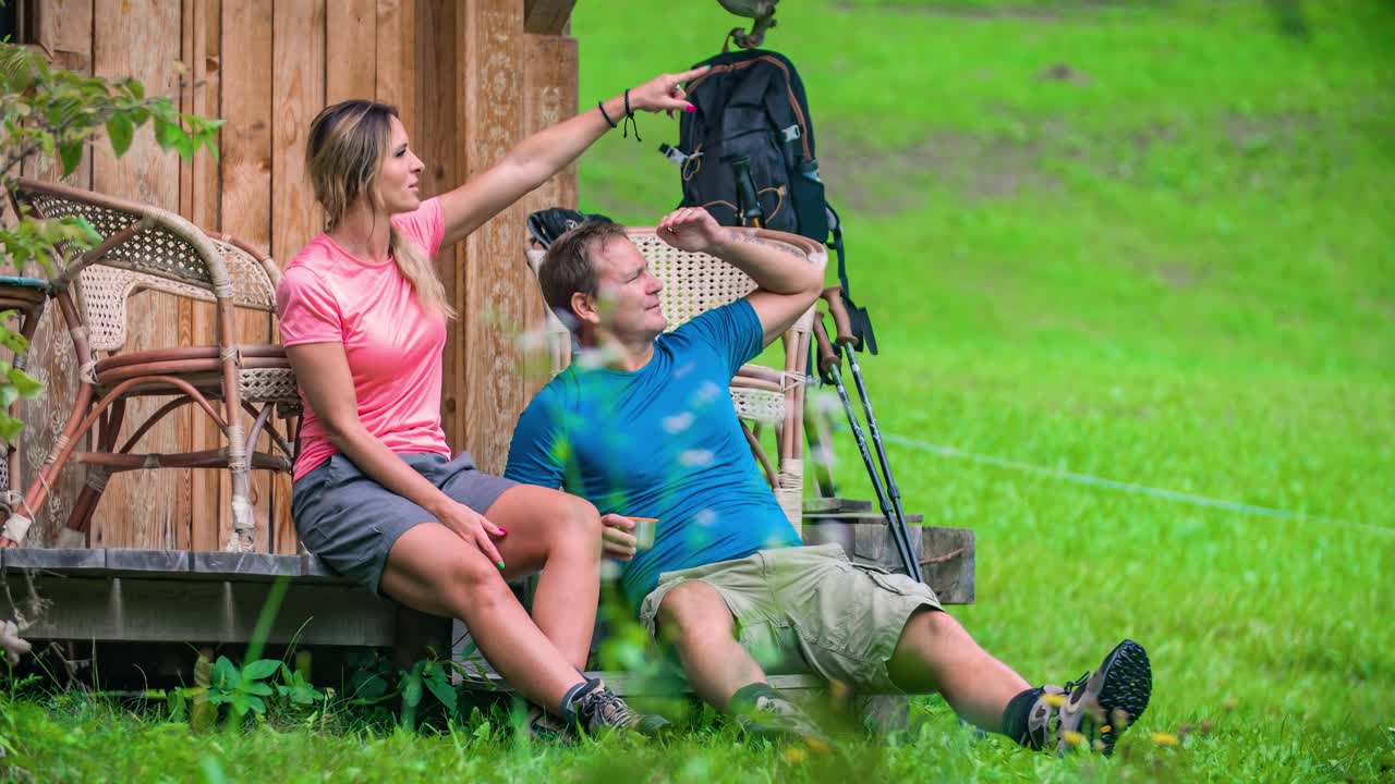 Couple of hikers resting and admiring view. Topla Valley in Slovenia