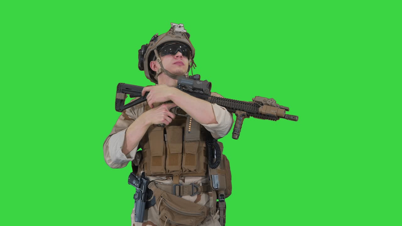 Tired US marine with a assault rifle standing on a Green Screen, Chroma ...