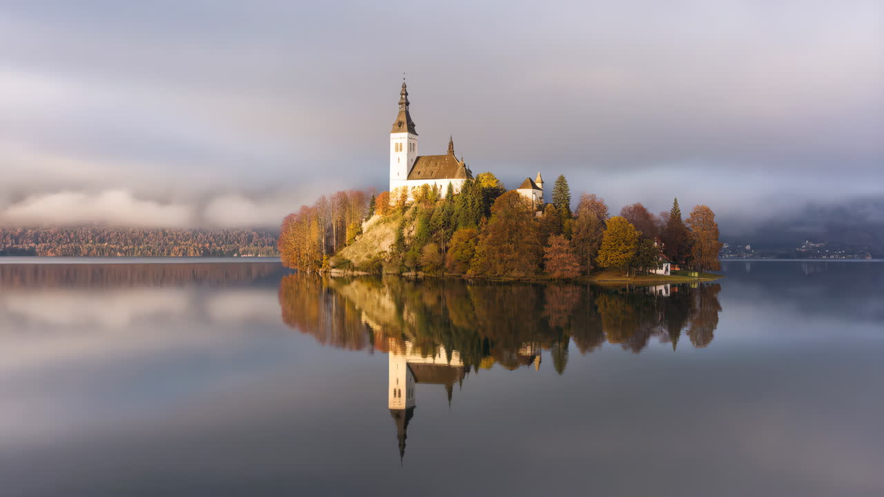 Lake Bled Island Church with Autumn Colors and Misty Reflections