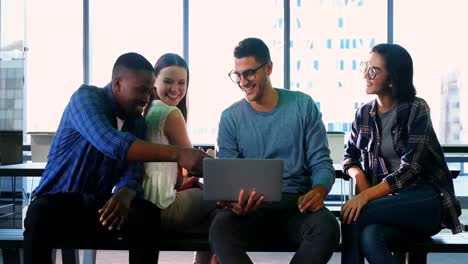 Business-colleagues-discussing-over-laptop-4k