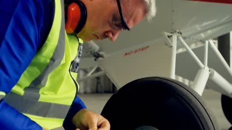 engineer reparing aircraft wheel