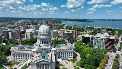 aerial view of madison, showcasing the stunning capitol building amidst the cityscape, with the serene backdrop of lakes and greenery