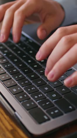 person typing on a laptop keyboard