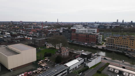 Ghent-cityscape-and-downtown-with-flowing-water-canal,-aerial-view