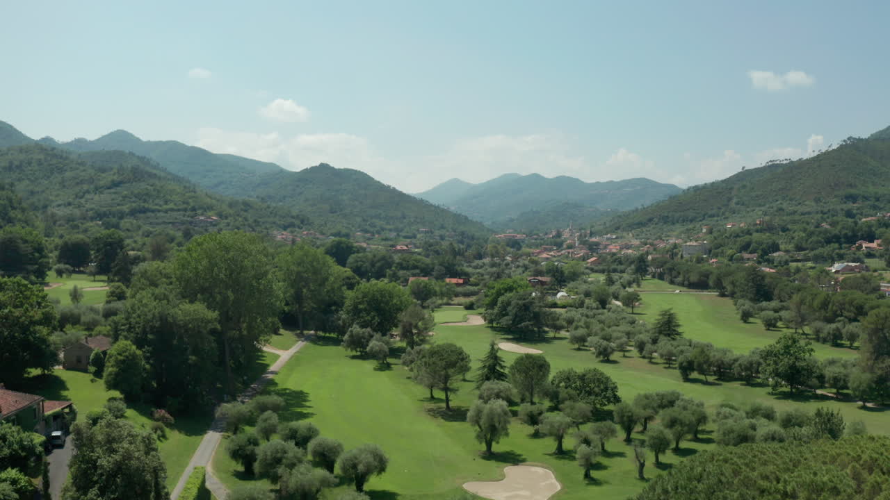 aérea que se eleva sobre el pintoresco parque de golf en el paisaje montañoso del norte de italia