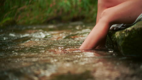 close-up of a woman's legs playing in the water