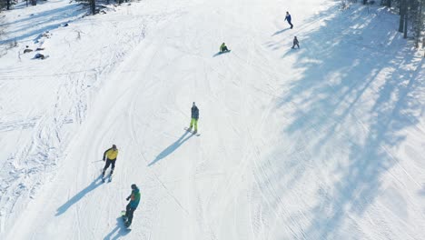 aerial view of skiers and snowboarders on a snowy slope