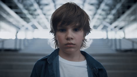 Preteen-boy-standing-alone-at-school-stairs-closeup.-Schoolboy-feel-sad-unhappy