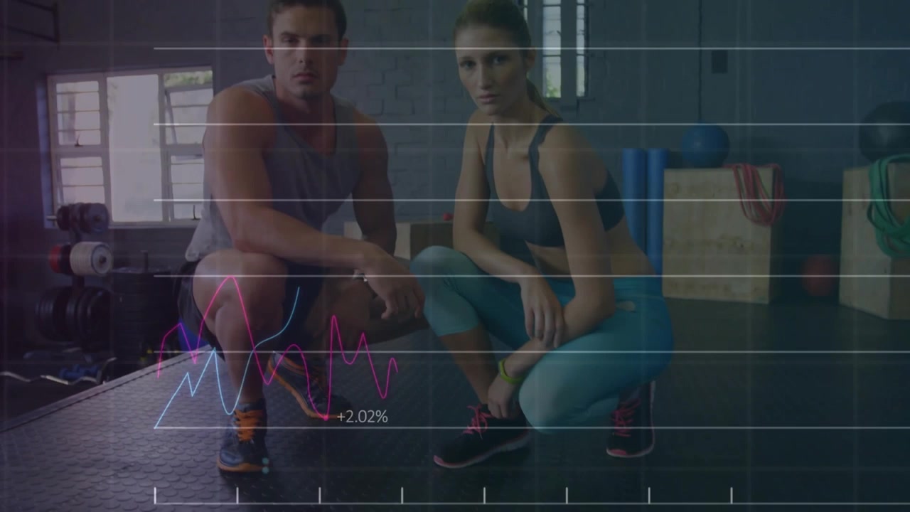 Squatting male and female duo wearing sleeveless top, blue leggings on gym floor, with data graphs