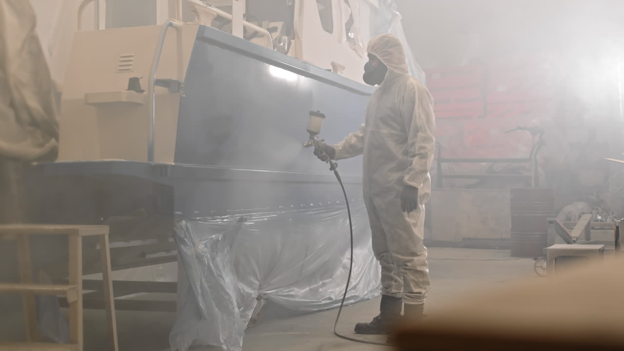 Person Spraying Boat with Airbrush