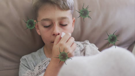 animation of virus cells over caucasian boy sneezing in bed