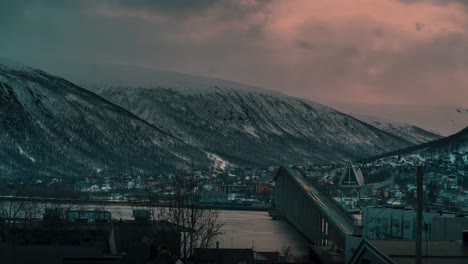 timelapse showing the bridge in tromso under a crazy winter sunset, clouds and sunlight mixing like crazy