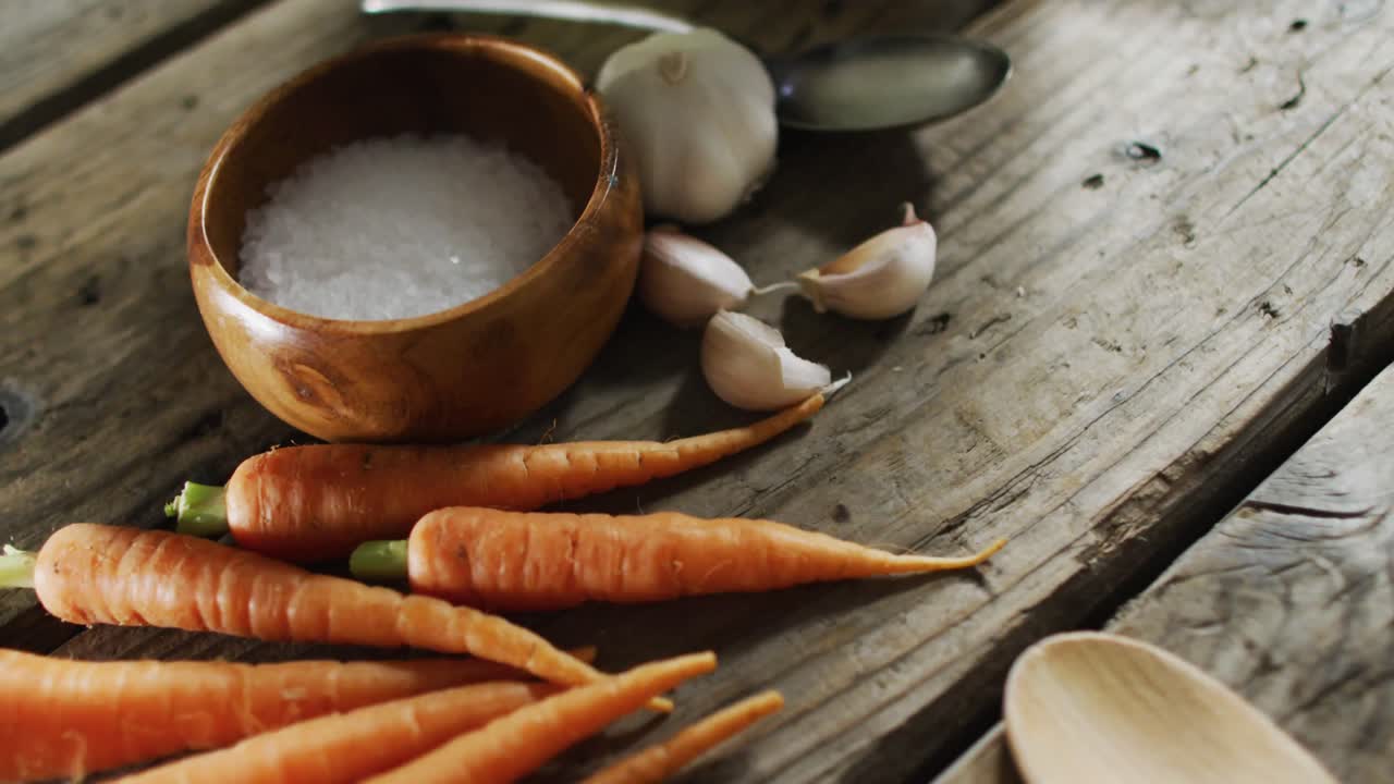 Close up view of multiple food ingredients and vegetables on wooden surface