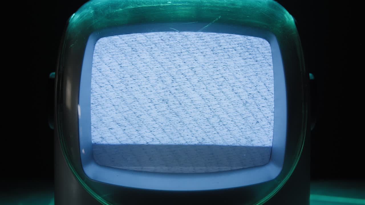 Retro TV, vintage television In a nostalgic setup, a retro TV displays grain on screen, scary halloween night device good for chroma key and green screen. High quality 4k footage