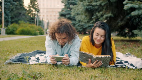 couple relaxing in park with dog