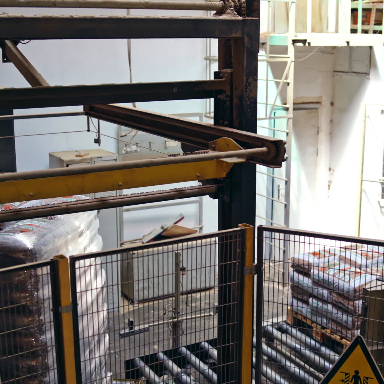 Mechanical robot with artificial intelligence sorts bags on the conveyor. Putting bags from line to the pallet. Process closeup.