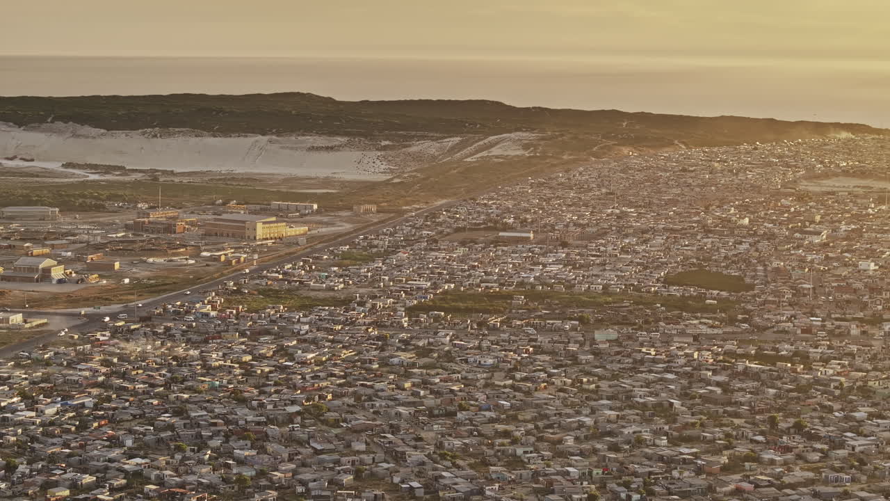 Cape Town South Africa Aerial v105 zoomed flyover township capturing wastewater treatment plant and Khayelitsha's vast, densely packed informal settlement - Shot with Mavic 3 Pro Cine - Jan 11th 2024