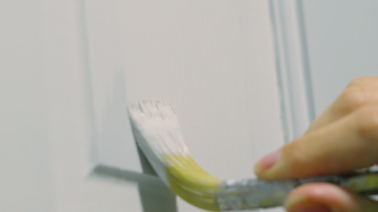 Painter Decorator Painting White Paint on Wooden Door Doing DIY to Decorate Home in Slow Motion 4K