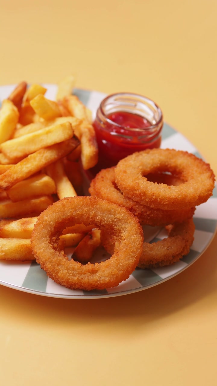 Delicious French Fries and Crispy Onion Rings with Ketchup