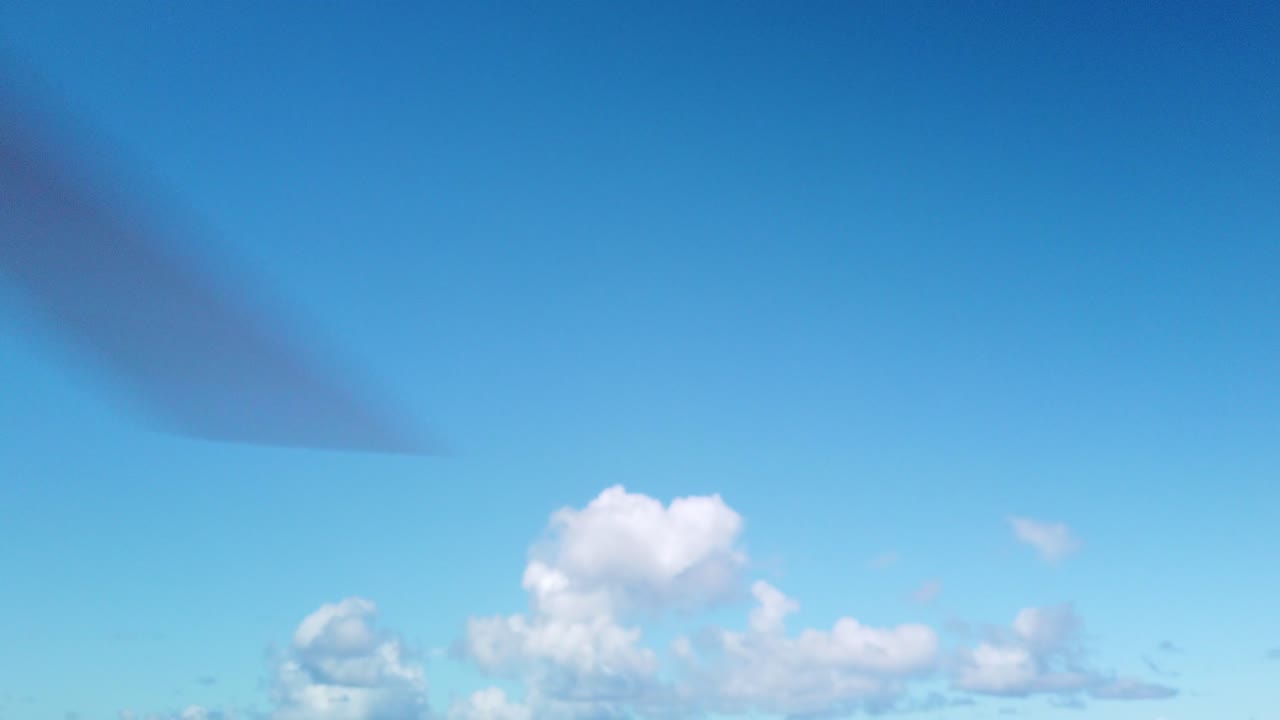 Gimbal close-up booming down shot of helicopter rotor blades spinning up at a heliport on the Hawaiian island of Kaua'i