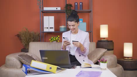 home office worker young woman shopping on the phone.