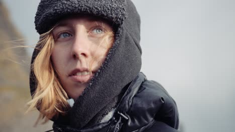 woman with beanie looking around cloudy day