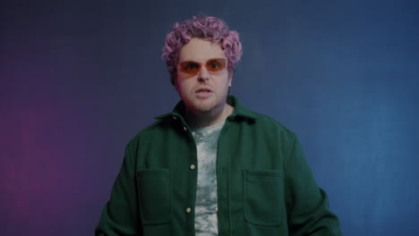 angry man with pink hair and sunglasses