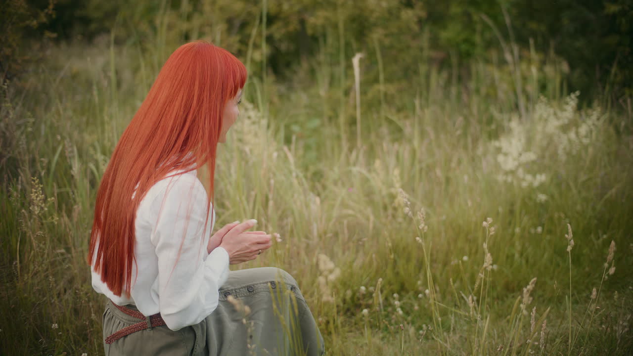 Woman petting dog in grassy field
