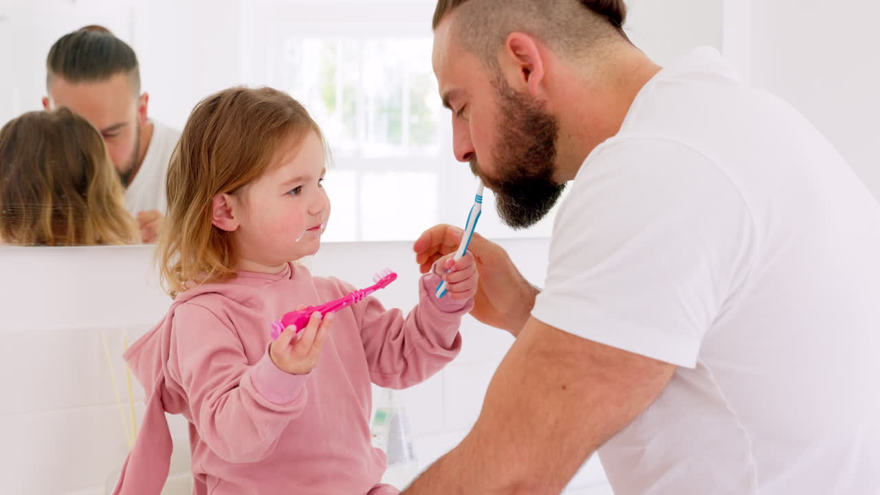 Father and Daughter Brushing Teeth