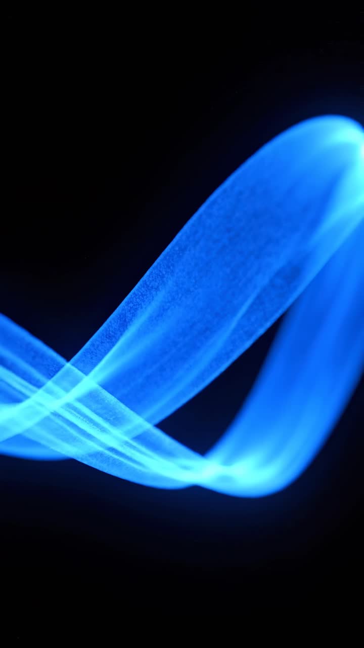 Abstract video concept with glowing blue light trails on a black background, shot from a side angle