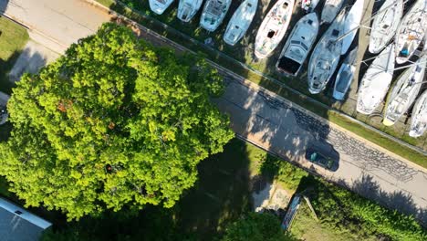 direct aerial over a boatyard full of sails near a small suburb