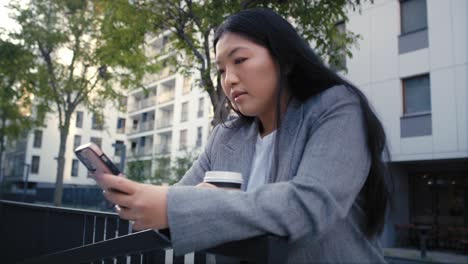 business chinese woman browsing mobile phone