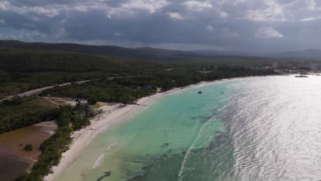 aerial view of aerial view of trelawney coastline, jamaica, showcasing turquoise waters, white sand, and lush coastal scenery