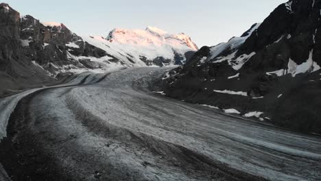 Sunset-flyover-over-Corbassiere-glacier-in-Valais,-Switzerland