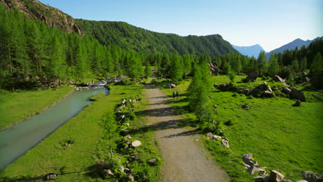 people walking surrounded by nature of val masino in valtellina, italy