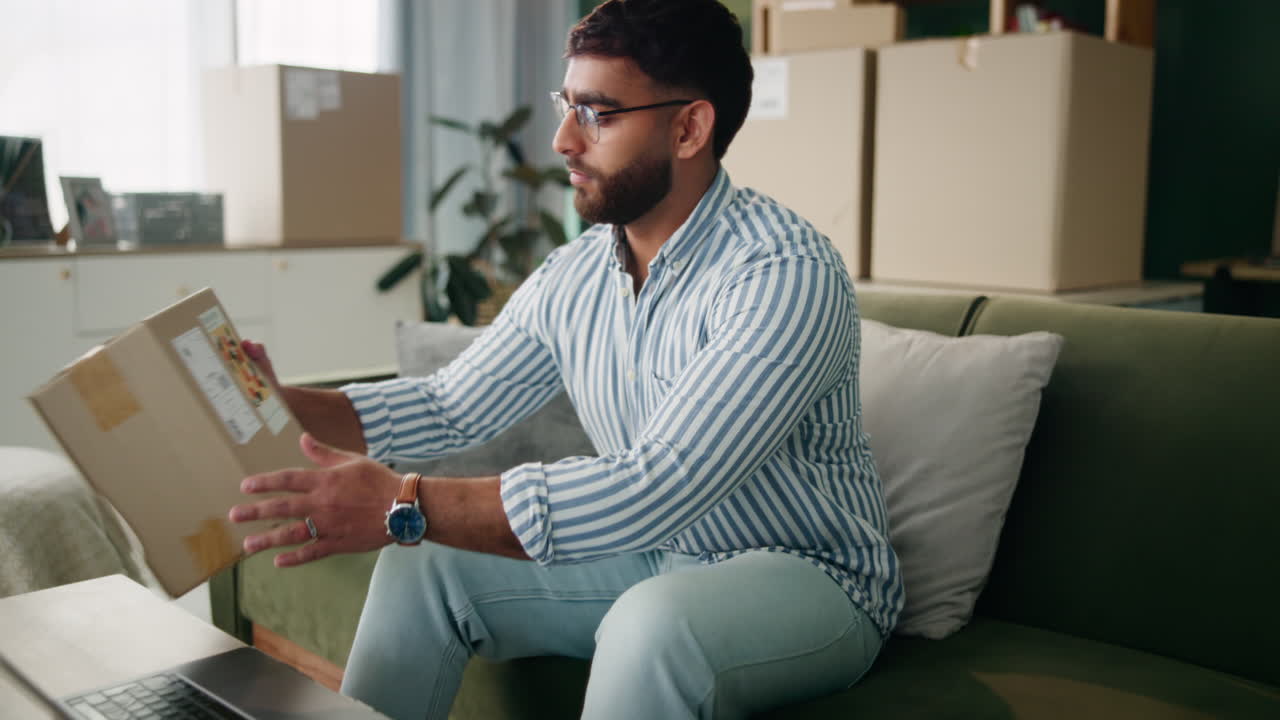 Man with a box in his living room