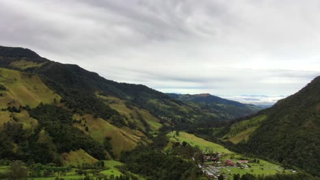 aerial view of grass and tree covered mountains in the colombian andes