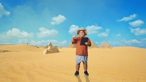 boy with tablet in front of egyptian pyramids
