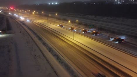 convoy of snow plows clearing montreal highways after blizzard
