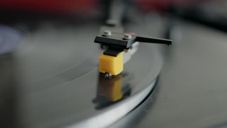 close-up of a record player needle on a spinning vinyl record, highlighting the vintage audio setup