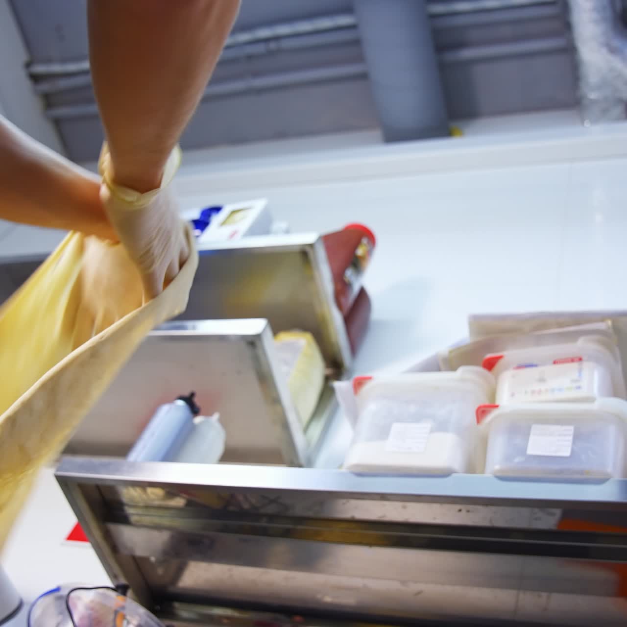 Dough for pizza in cooker's hands. Hands are spinning pizza dough in the air. Process of forming dough. Preparing pastry. Slow motion. View from below
